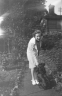 neg. Margaret? back of house & dog